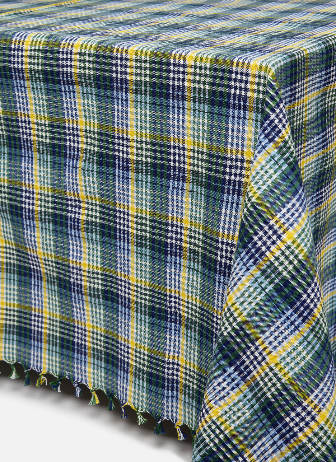 Maine plaid tablecloth draped over a table showing the tasseled edge and multicolor check