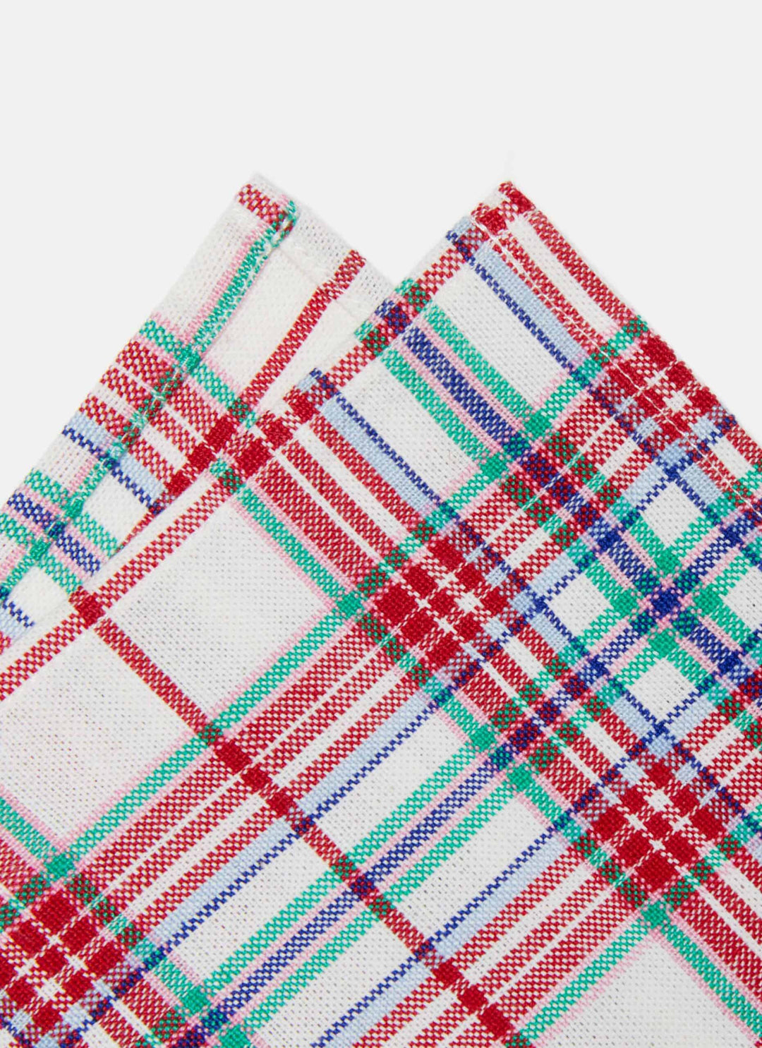 Close-up of two Clara plaid napkin corners showing the red, emerald, and indigo weave