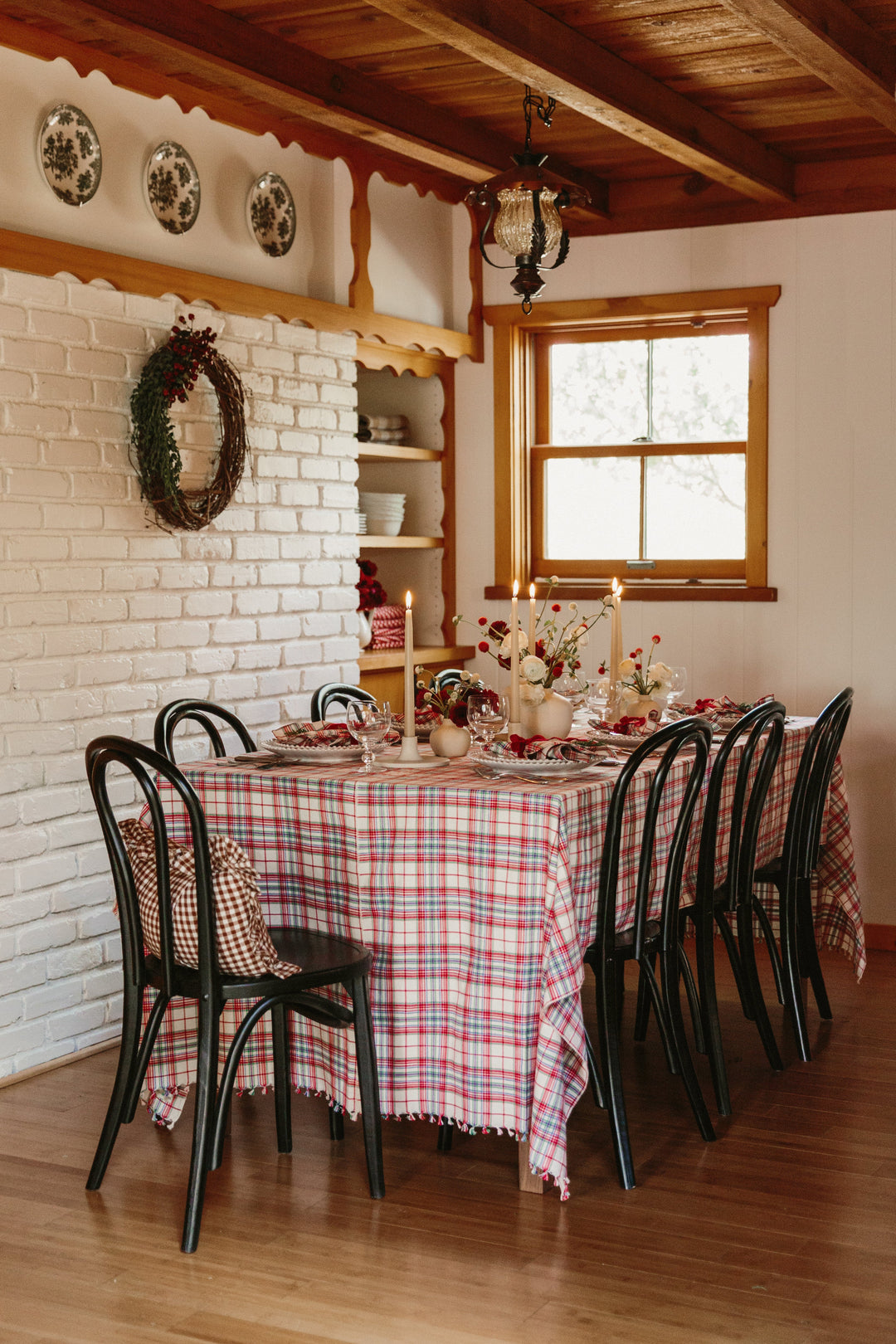 Clara plaid tablecloth laid flat on white showing the full plaid and knotted tassel edge