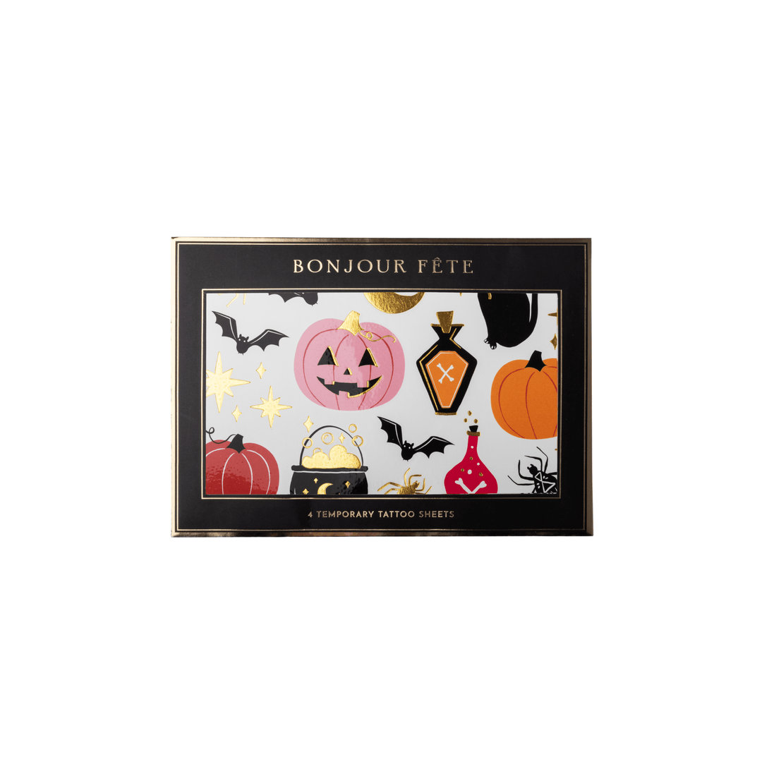 A set of Halloween-themed temporary tattoo sheets. The black rectangular box has gold trim and the text 'BONJOUR FETE' at the top, with a colorful front panel showing pumpkins, bats, a cauldron, a potion bottle, a spider, and gold stars on a white background.