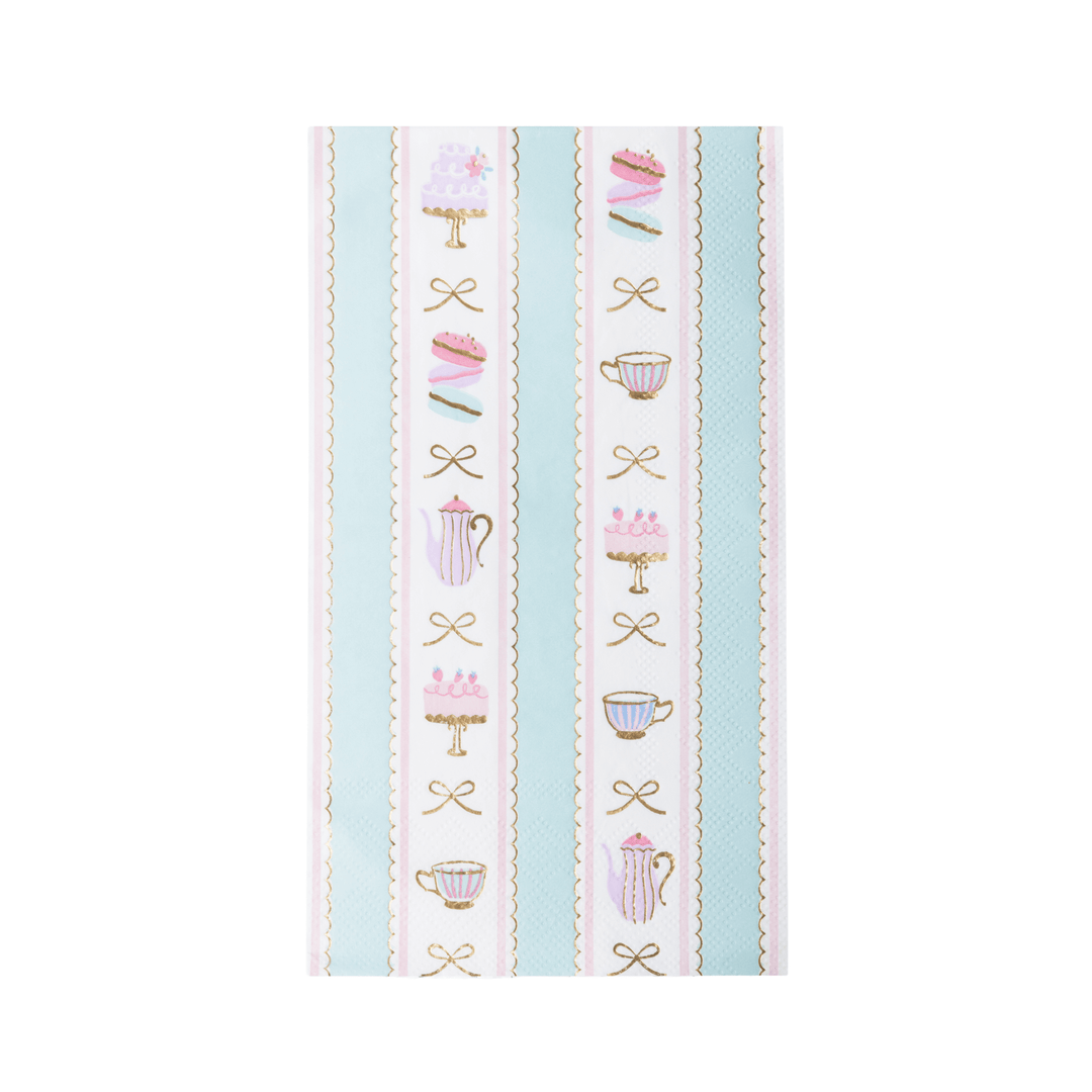 A rectangular paper napkin featuring a vertical striped pattern with pastel pink cakes on stands, teacups, teapots, and bows on a white background with light blue stripes.