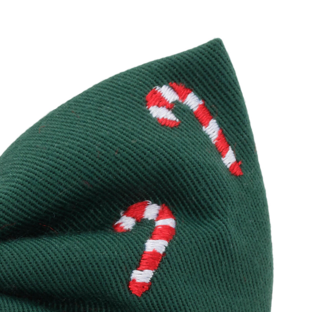 Close-up of embroidered candy canes on the tail of the evergreen bow
