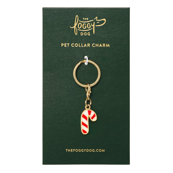 Red-and-white candy cane collar charm with gold hardware mounted on a green Foggy Dog backing card.
