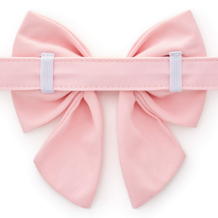 Back of the blush sailor bow showing two white elastic loops around the collar