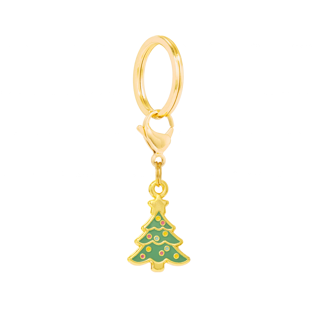 Green Christmas tree enamel collar charm with gold star, colorful ornaments, and gold hanging hardware on white.
