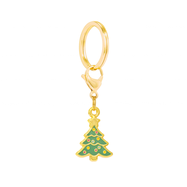 Green Christmas tree enamel collar charm with gold star, colorful ornaments, and gold hanging hardware on white.