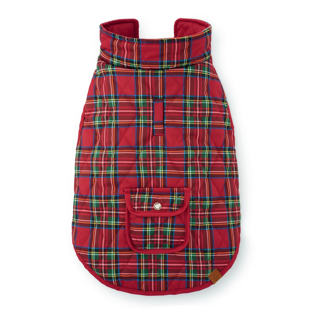 Back of a red tartan quilted dog jacket showing its standing collar, leash opening, and snap pocket.