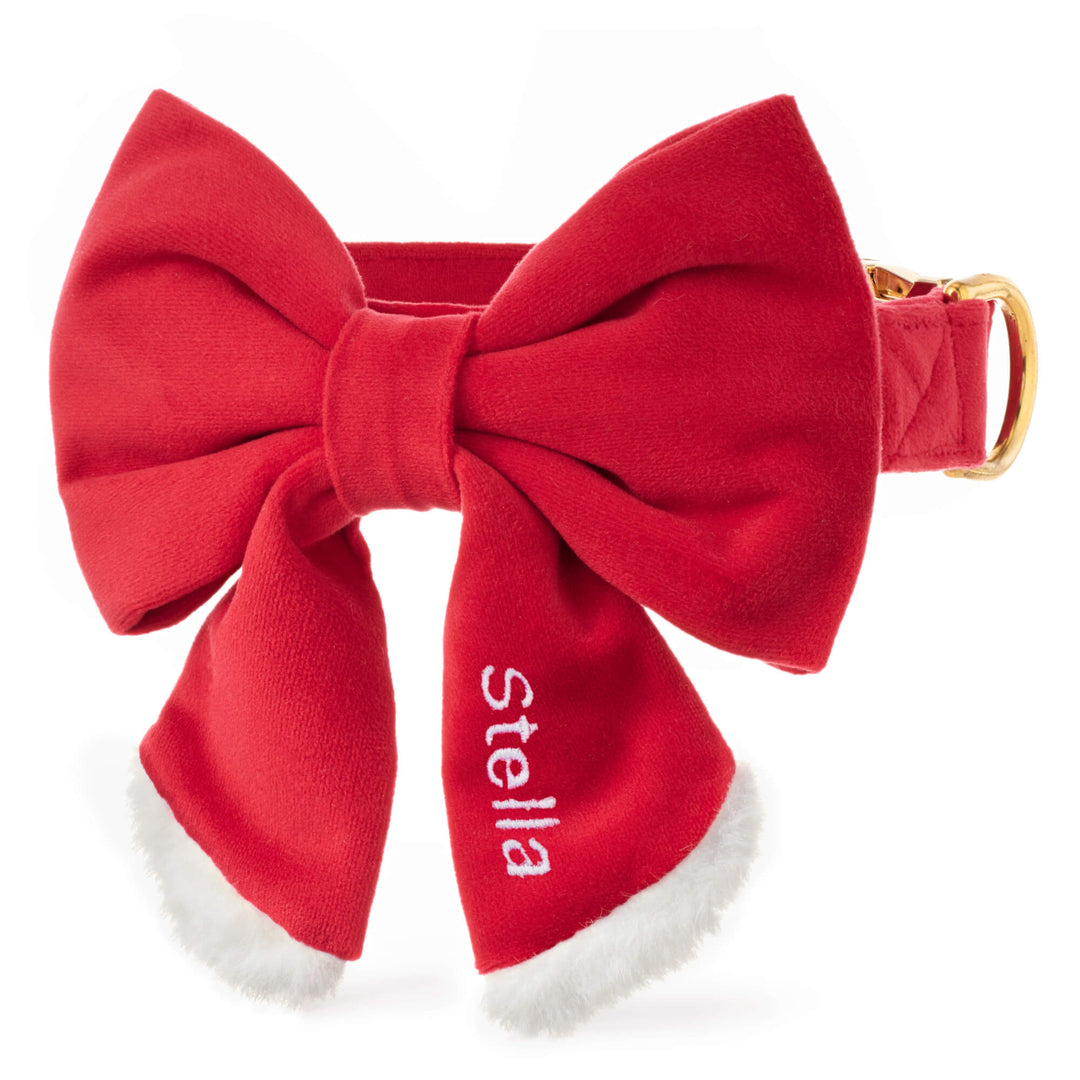 Red Santa Paws collar and sailor bow with white fluffy trim, sample name embroidered on the tail