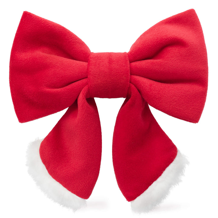 Red Santa sailor dog bow with white faux fur trim along both tails, front view on white