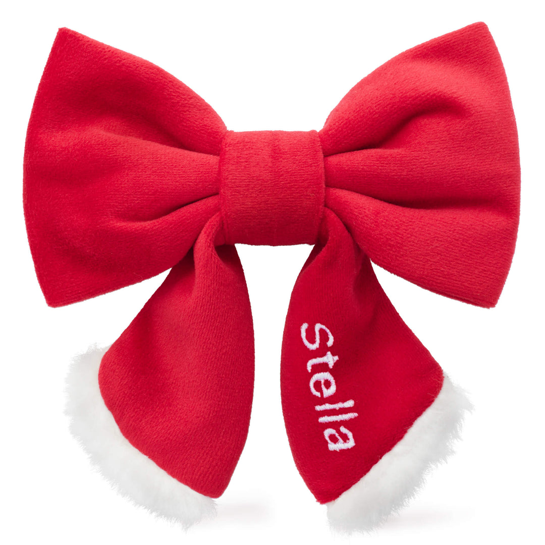 Santa lady bow with a name embroidered on one tail, showing a personalization option from the maker