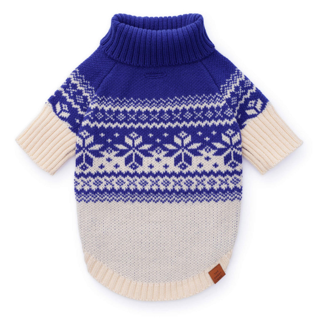 Blue-and-cream Fair Isle dog sweater laid flat with a snowflake yoke and ribbed blue turtleneck.