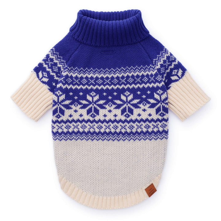Blue-and-cream Fair Isle dog sweater laid flat with a snowflake yoke and ribbed blue turtleneck.
