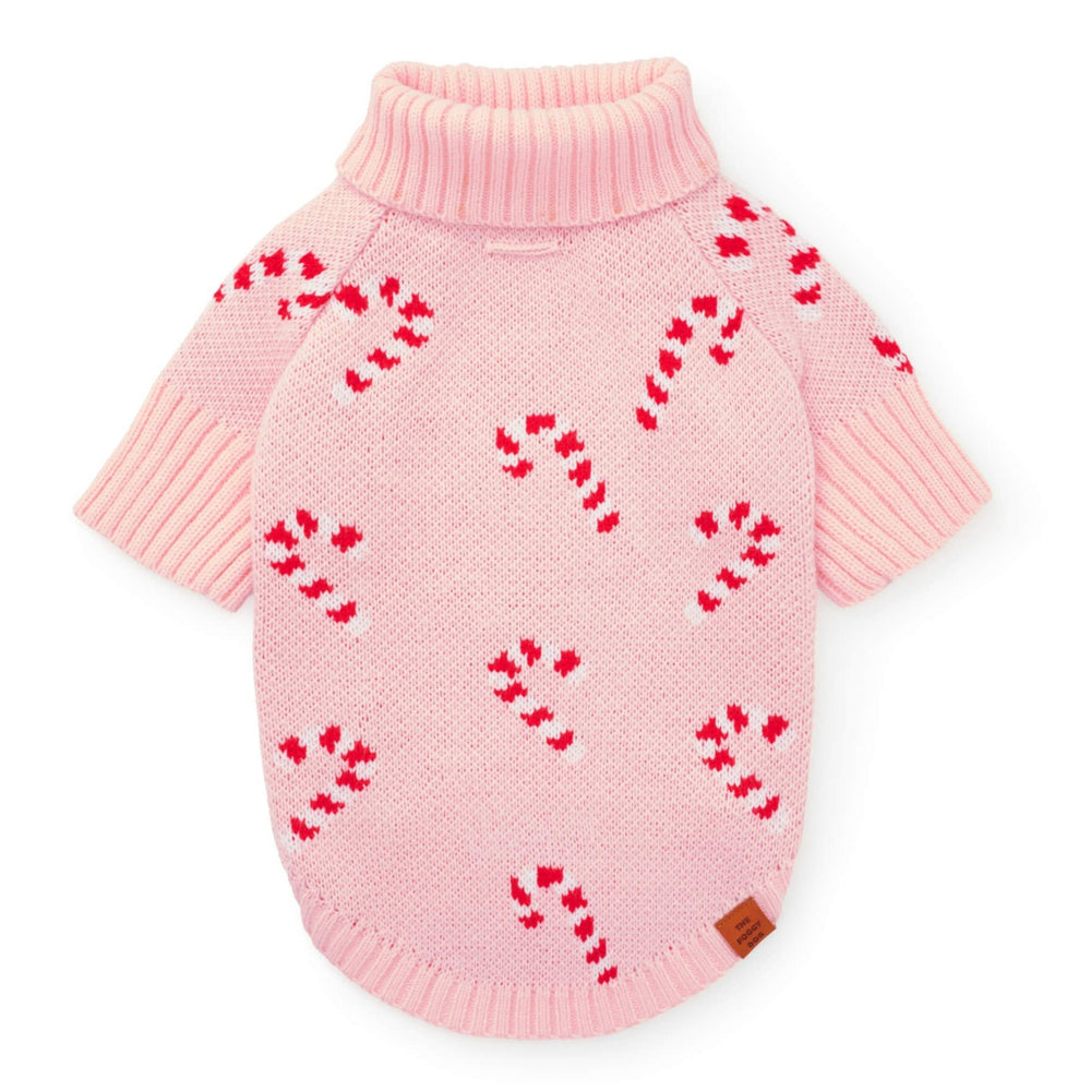 Blush pink knit dog sweater flat from the back, scattered with red and white candy canes, on white