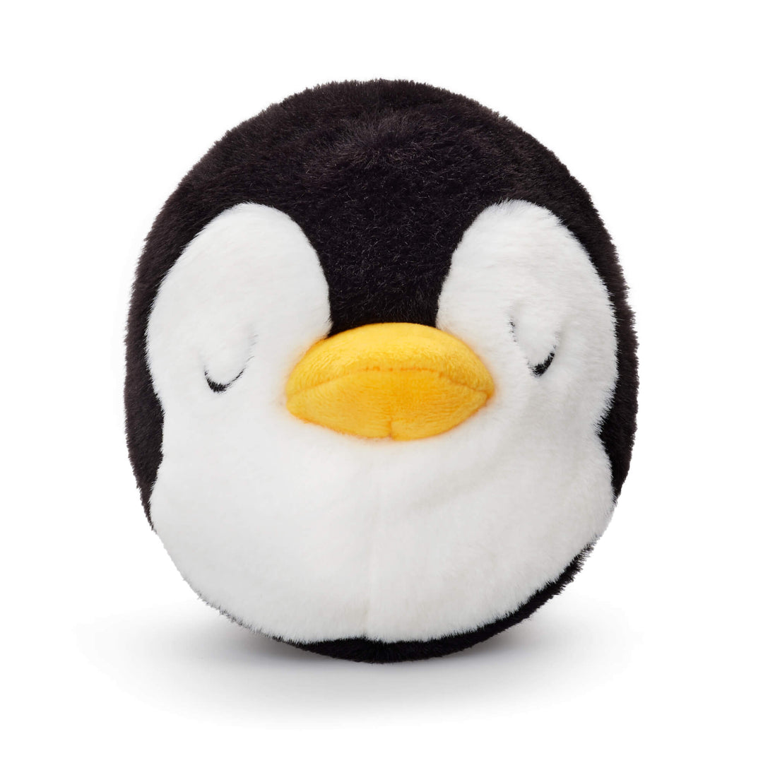Close-up of the penguin dog toy's sleepy embroidered eyes, white face, and bright yellow beak.