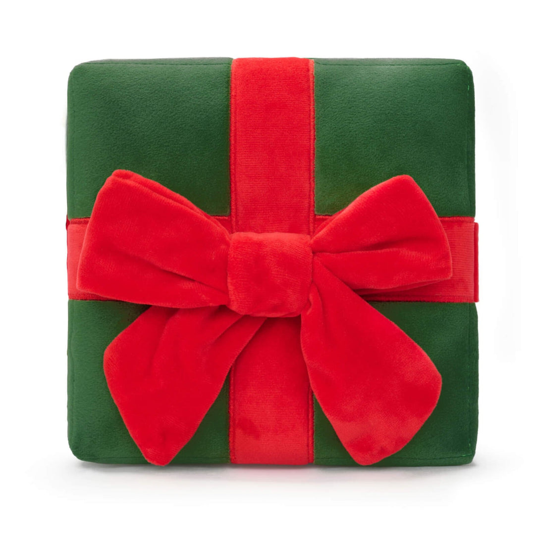 Close front view of the green Christmas present snuffle mat toy and its red bow on white