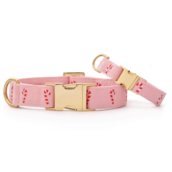 Large and small pink candy cane collars side by side on white