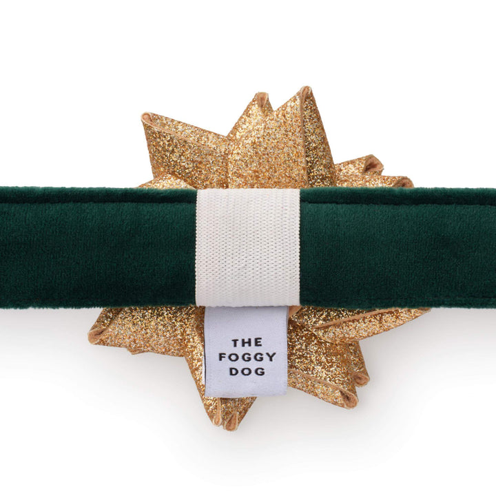 Back of the green velvet collar with the gold bow held on by a white elastic loop