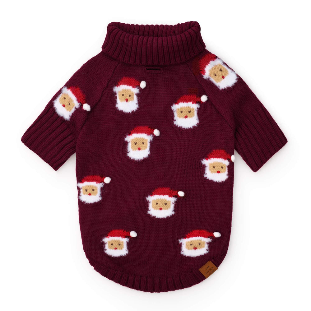 Burgundy dog sweater laid flat with repeated red-hatted Santas and fluffy white beards.