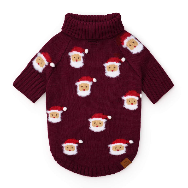 Burgundy dog sweater laid flat with repeated red-hatted Santas and fluffy white beards.