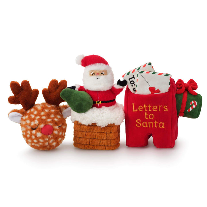 Reindeer, Santa chimney, and Letters to Santa mailbox dog toys lined up together on white