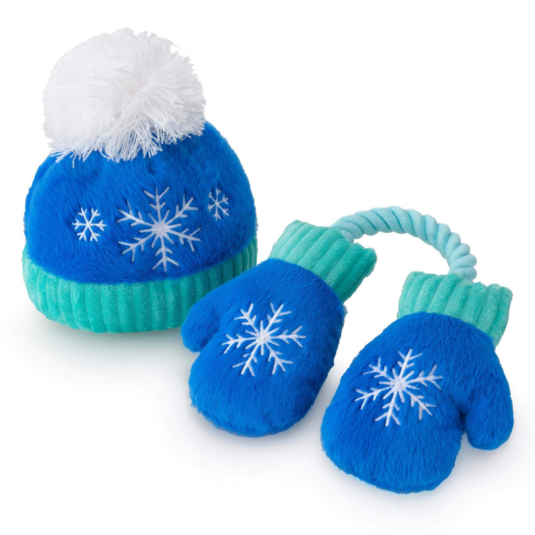 Royal blue snowflake beanie dog toy with white pom-pom and rope-linked blue mittens on white