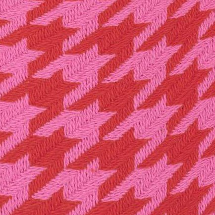 Close-up of the woven pink and red houndstooth fabric used for the dog collar and bow.