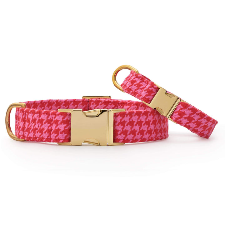 Two pink houndstooth collars, a large and a small, side by side on white