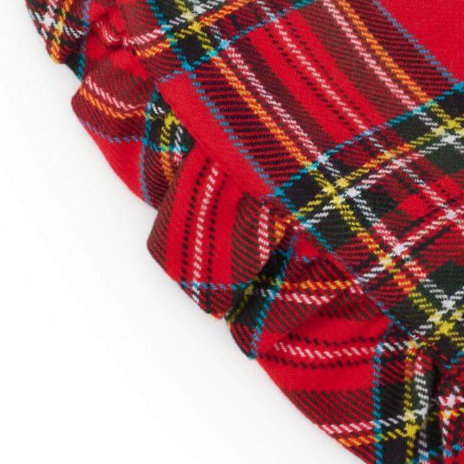 Close-up of red tartan flannel and the gathered ruffle along the bandana's edge.