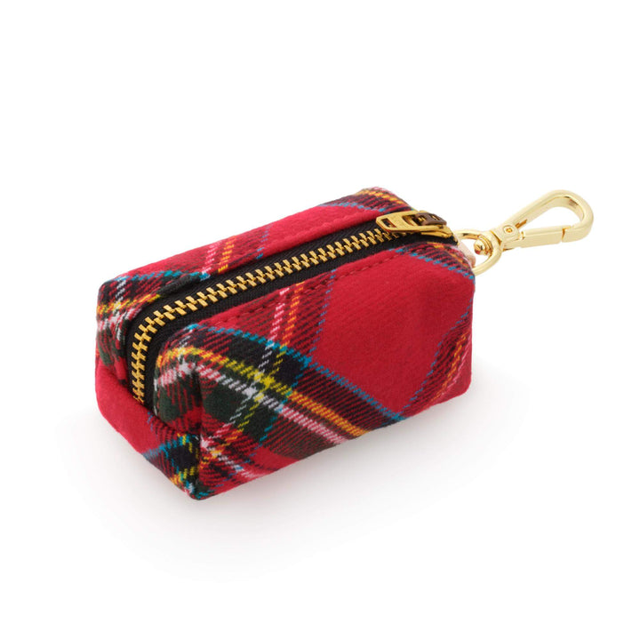 Angled side view of a red tartan dog waste bag holder showing the zipper and compact box shape.