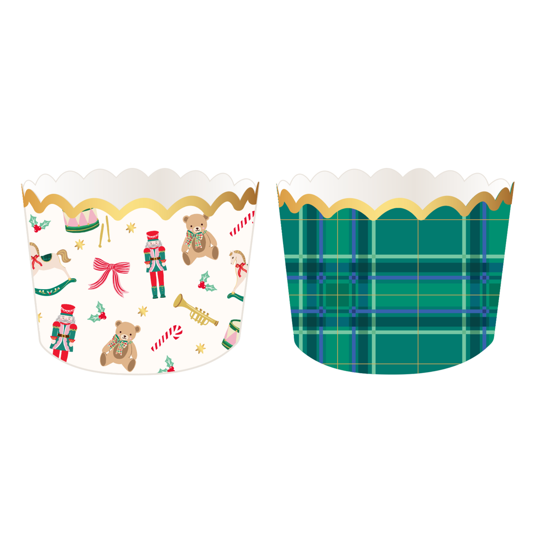 Two scalloped Christmas treat baking cups, one cream holiday toy print and one green tartan plaid, with gold rims