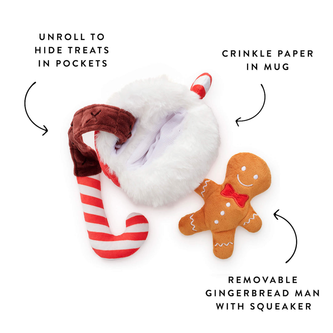 Cocoa toy taken apart: unrolled candy cane treat ribbon, crinkle mug, and squeaky gingerbread man