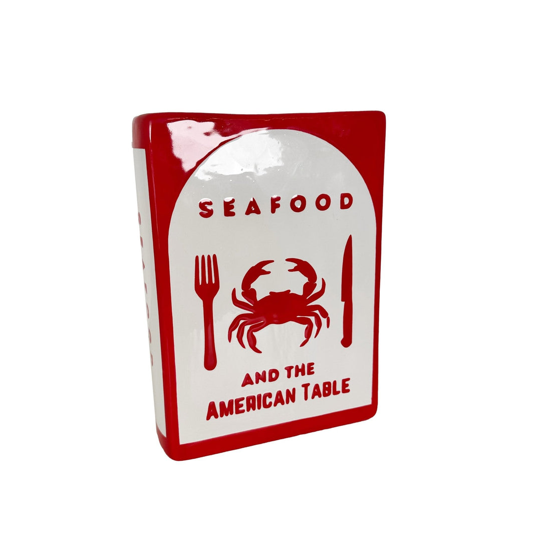 Decorative sign with red crab illustration and text on a white background