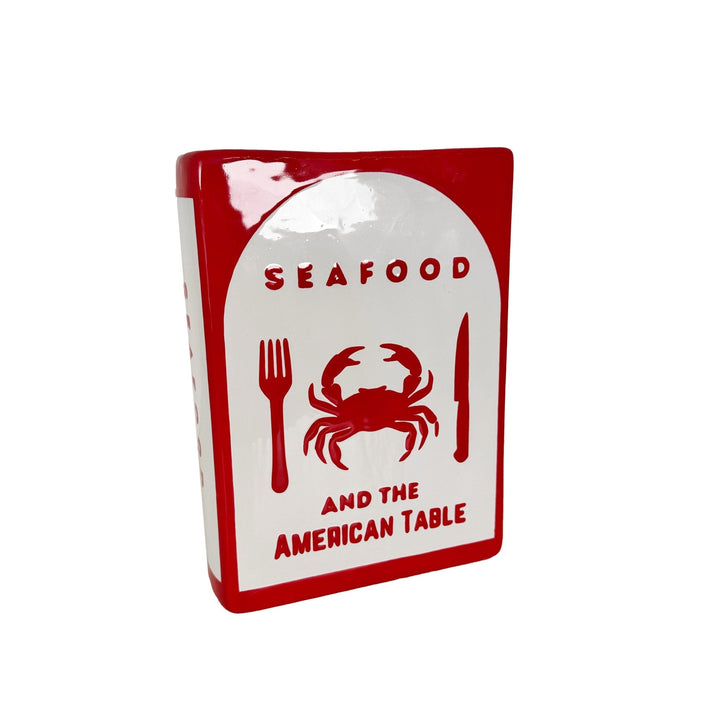 Decorative sign with red crab illustration and text on a white background