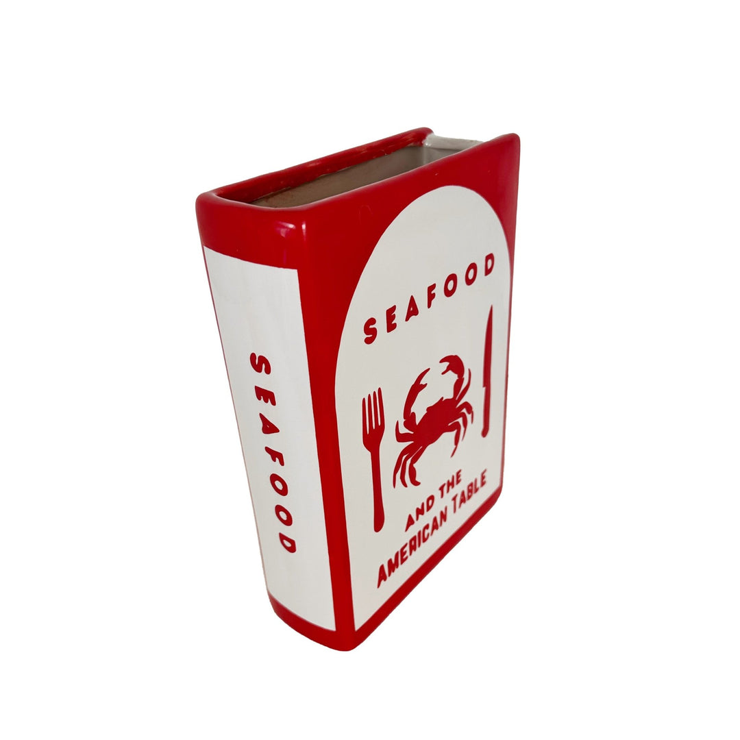Rectangular container with red and white design featuring a crab and text on a white background