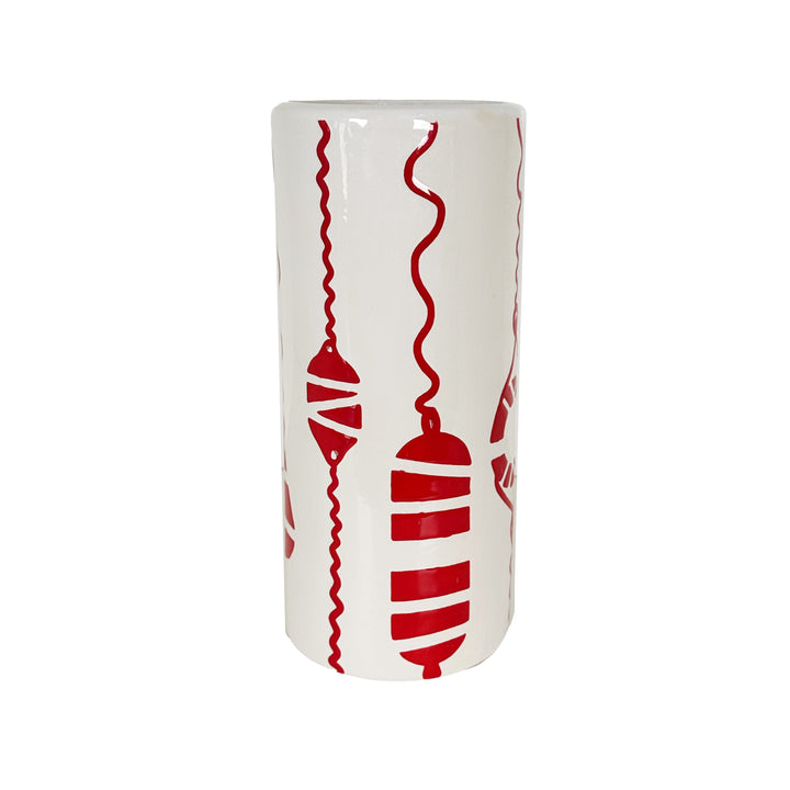 White cylindrical vase with red decorative patterns on a white background