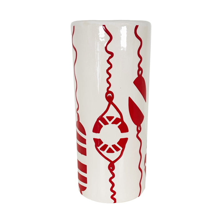 White cylindrical vase with red geometric patterns on a white background