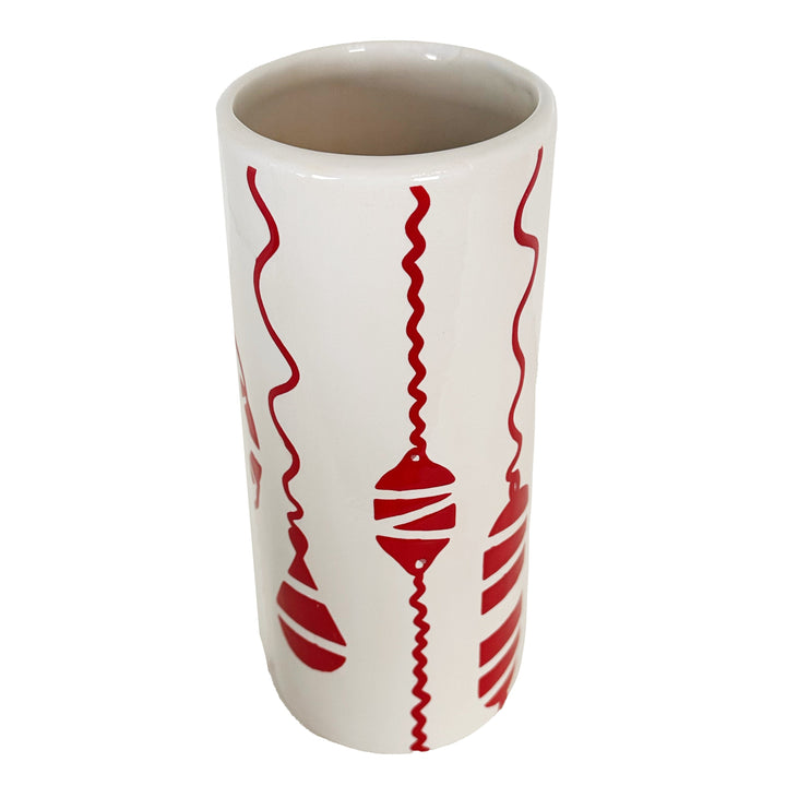 White mug with red decorative patterns on a white background