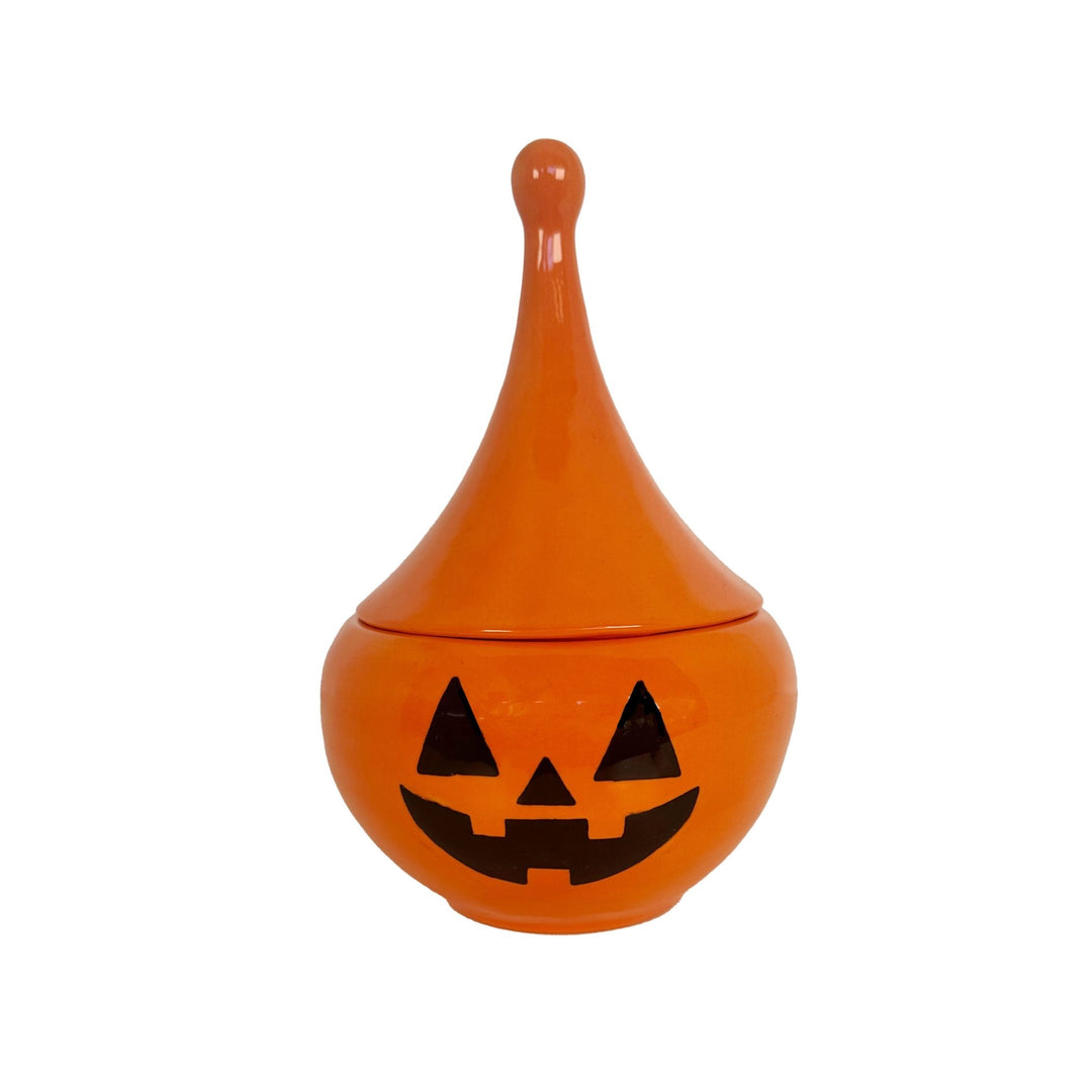 Orange ceramic jar with a jack-o'-lantern face on a white background