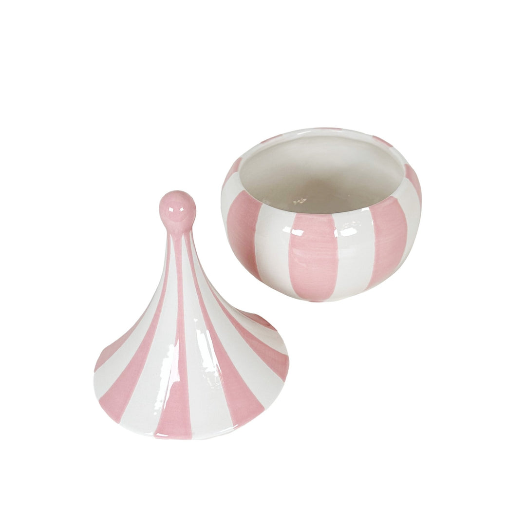 Pink and white striped fan and bowl on a white background