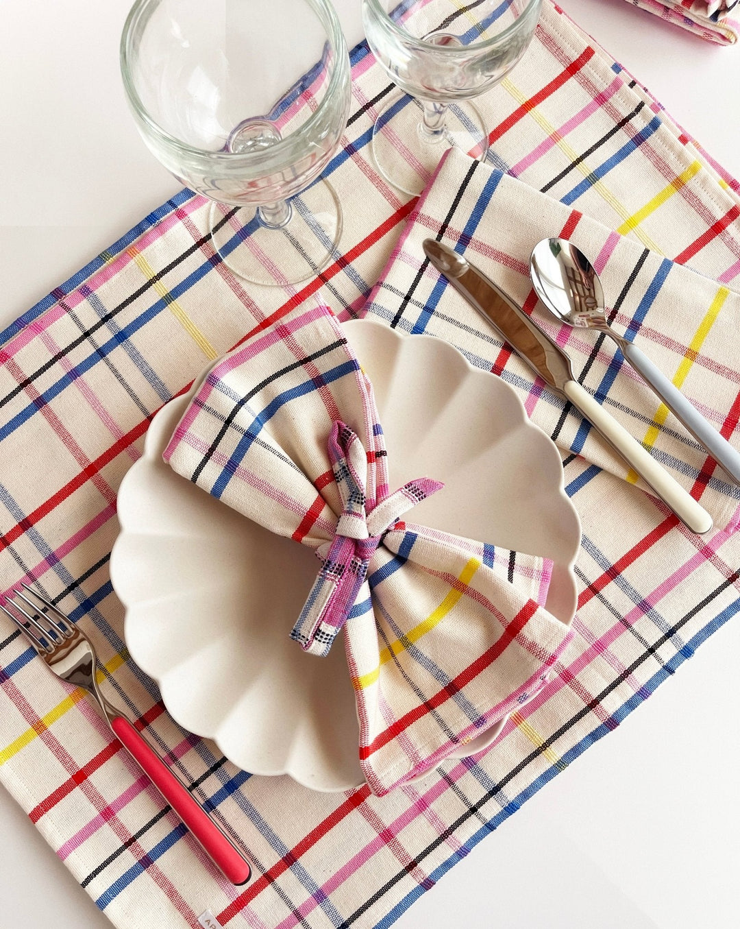 Vibrant multicolor plaid table runner styled with place settings