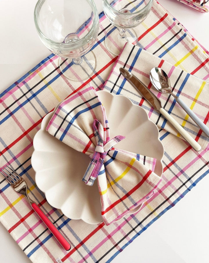 Vibrant multicolor plaid table runner styled with place settings