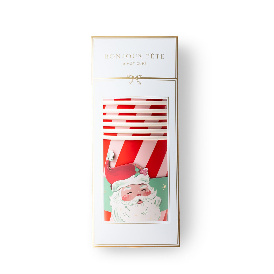A boxed set of 8 holiday-themed hot cups with the text 'BONJOUR FÉTE' and '8 HOT CUPS' on the packaging. The box is white with gold trim and features a festive illustration of Santa Claus and red-and-white striped cups visible through a clear window.