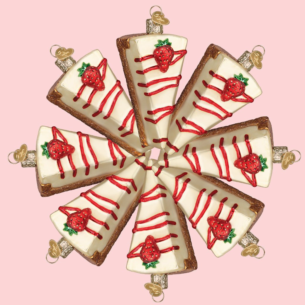 Ring of cheesecake slice ornaments arranged in a circle on a pink background