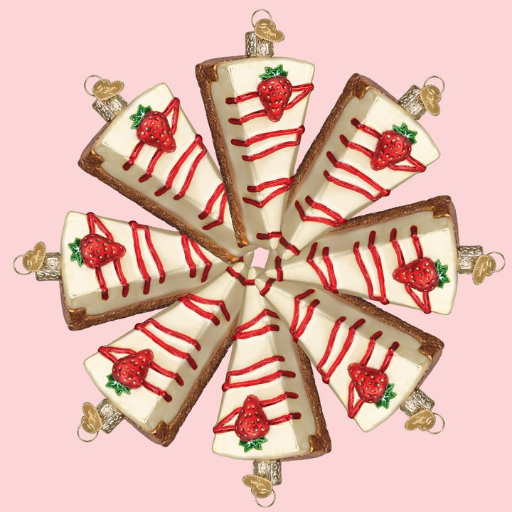 Ring of cheesecake slice ornaments arranged in a circle on a pink background