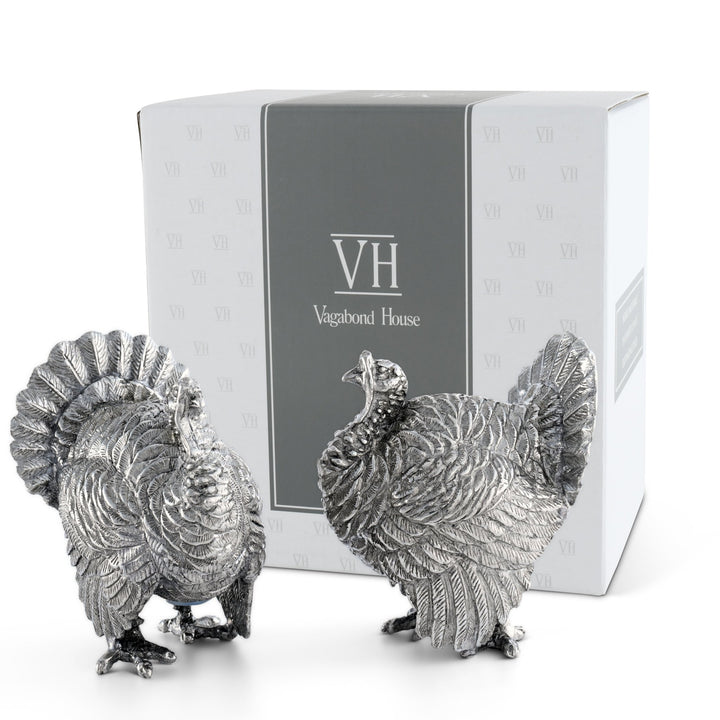 Pewter turkey salt and pepper shakers standing in front of a white Vagabond House gift box