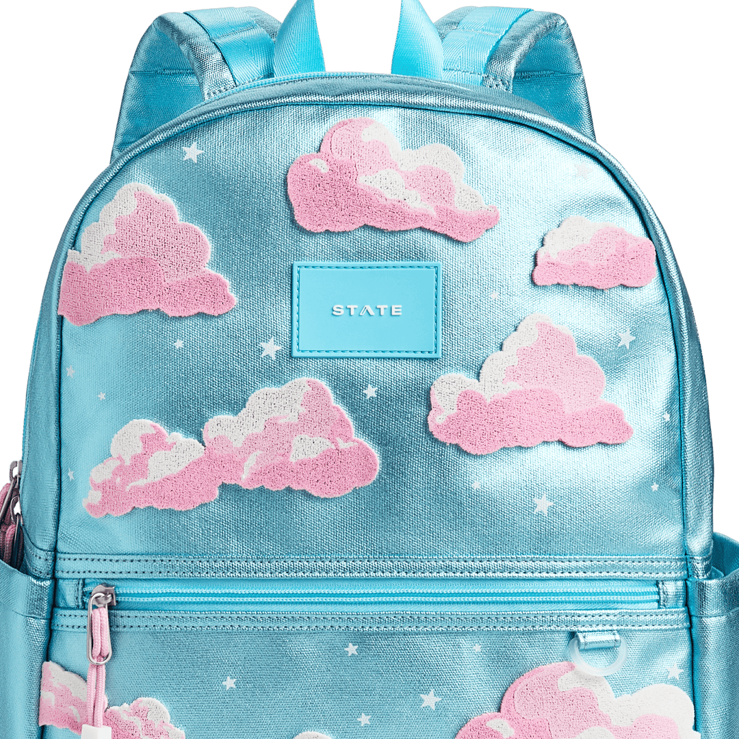 Close-up of the textured pink clouds, white stars, and blue STATE patch