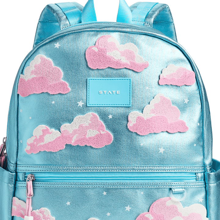 Close-up of the textured pink clouds, white stars, and blue STATE patch
