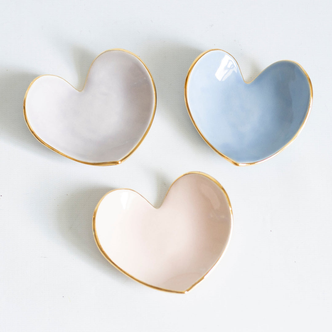 Three heart ring dishes in lavender, French blue, and blush pink with gold rims
