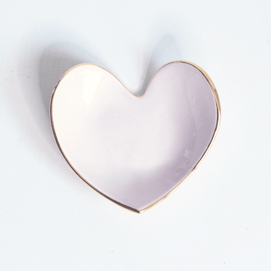 Soft lavender heart ring dish with a gold rim, top view on white