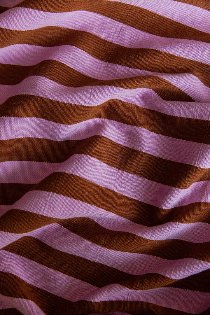 Close-up of the handwoven cotton weave in the lilac and nutmeg brown stripe